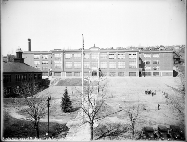 View of high school building with broad lawn