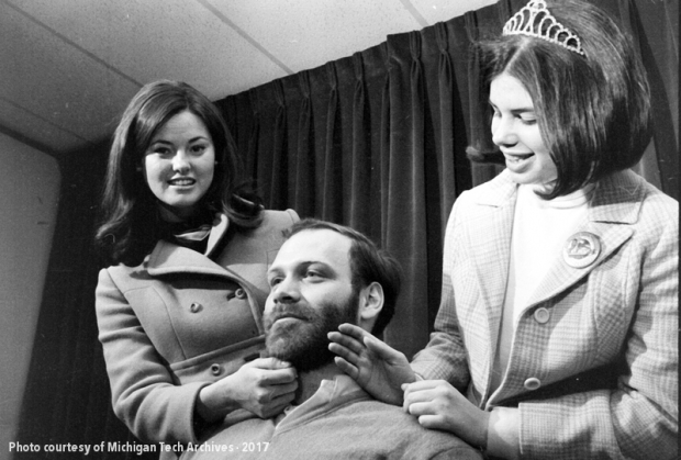 The 1970 carnival queen judges the beard contest.